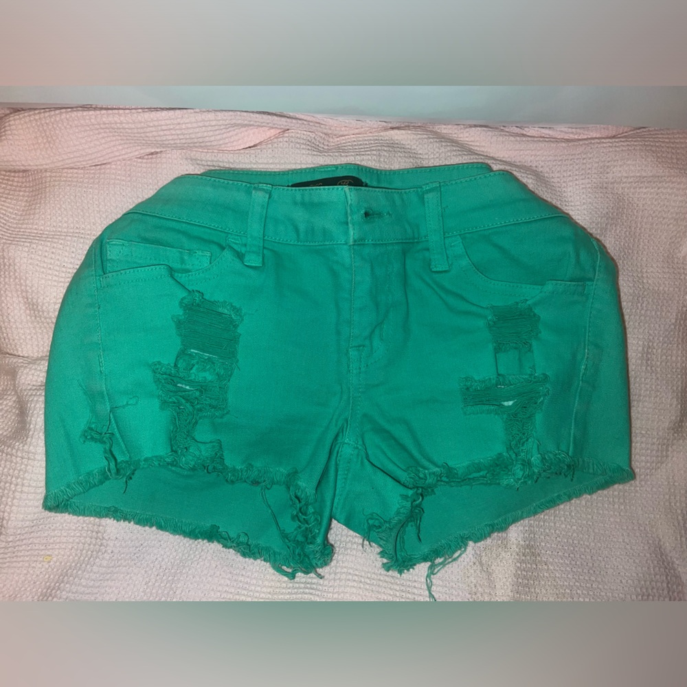 Low waist butt enhancing stretch fringe distressed button ripped jean shorts